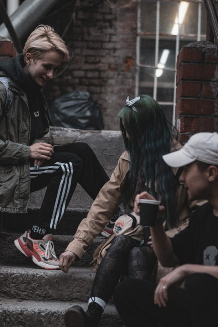 man in black jacket sitting beside woman in black jacket