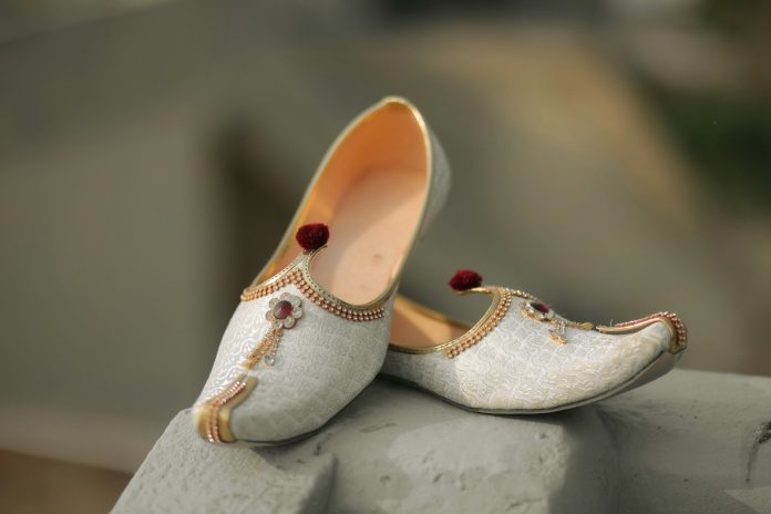 Ornate white and gold traditional indian shoes